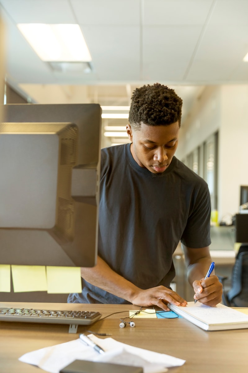 Man writing on paper — planning a project